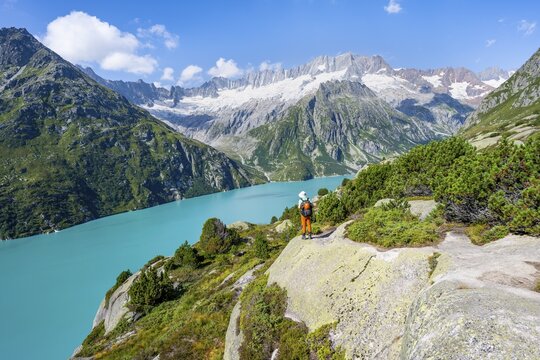 Mountaineers in front of picturesque mountain landscape, turquoise-blue mountain lake G&ouml;scheneralpsee, Dammastock and Damma Glacier, G&ouml;scheneralp, Canton of Uri, Switzerland