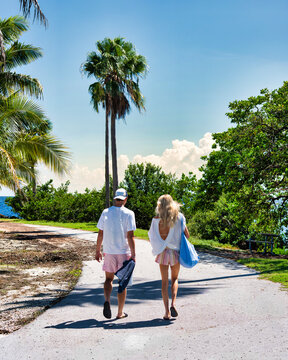 Couple Walking Toward a Tropical Beach on a Sunny Vacation