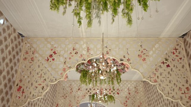 Luxury Event Ceiling Decoration Featuring Hanging Flowers, Foliage, and Crystal Chandelier