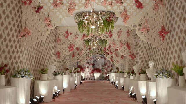 Luxury Event Walkway with Floral Ceiling Hanging Chandeliers and Classical Busts Decor