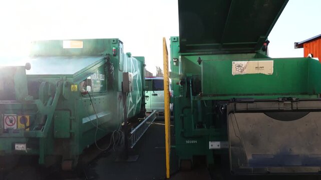 Gothenburg, Sweden  A garbage compactor crushes cardboard into a container. 