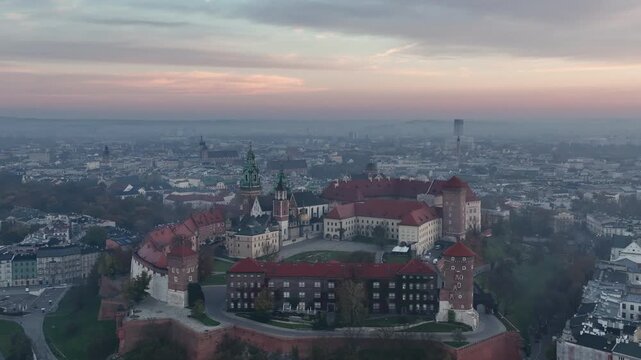 Wawel Castle and Cathedral at pink sunrise over misty Krak&oacute;w