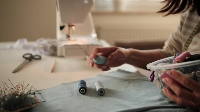 Seamstress Matches Thread To Fabric Color With Hands Up Close