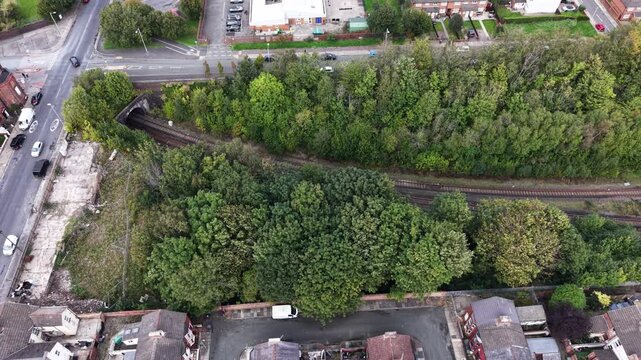 Aerial drone 4K view of Birkenhead Park lakeside and housing rows glowing in warm daylight Birkenhead Park UK