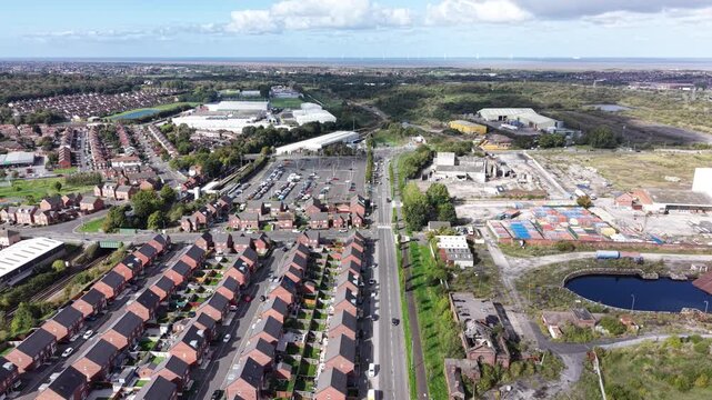 Aerial drone 4K scene showing Birkenhead Park pathways illuminated by warm daylight with housing rows glowing beside the park Birkenhead Park UK