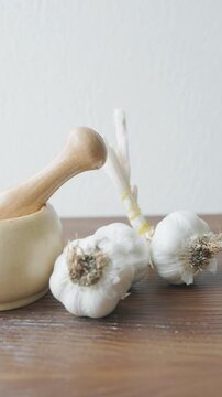 garlic mortar and pestle with fresh garlic cloves close up
