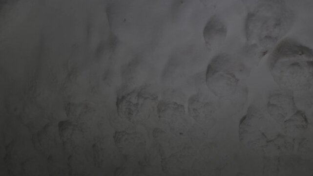 The salt cave walls on Qeshm Island feature textured mineral and crystalline salt formations. Close-up view of natural geological patterns and underground deposits. ProRes 422, 10-bit, C-Log video..