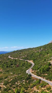 Croatia, aerial view of a winding road along the coastline and mountains
