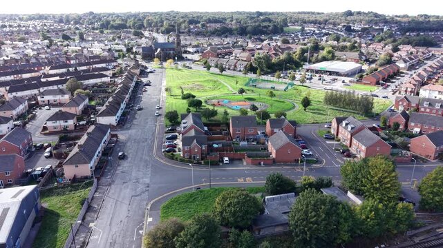 Aerial drone 4K view of Birkenhead Park pathways and surrounding housing glowing in warm afternoon light Birkenhead Park UK