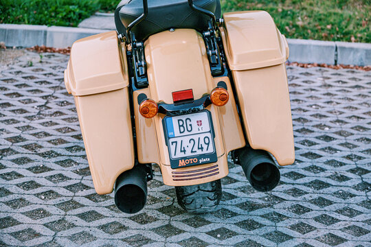 August 14, 2026, Kosmaj, Serbia: Cruiser motorcycle rear view with saddlebags, SRB license plate, parked on paving stones.