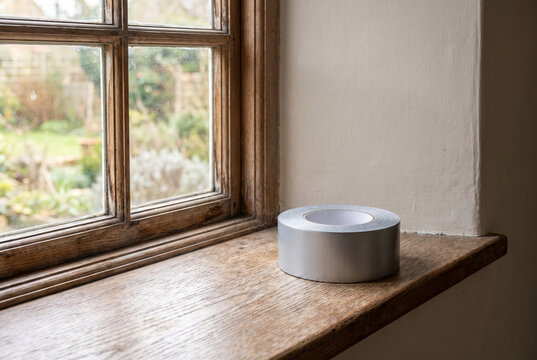 Air sealing tape roll beside a window frame