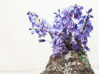 Bluebells bloom on textured rock surface. Delicate purple flowers hang gracefully. Soft focus highlights natural beauty. Ideal for spring themes or floral design projects © mark_gusev