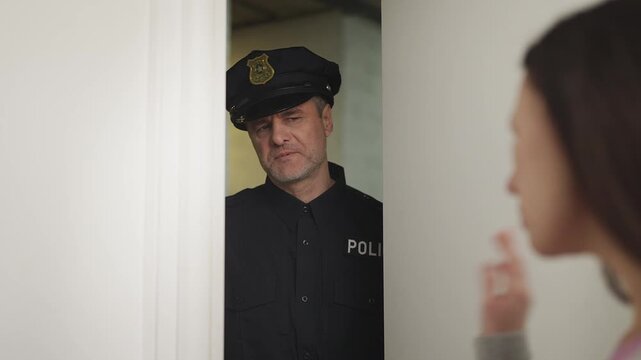 Reluctant female witness avoids police questioning at apartment doorway