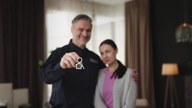 Happy police officer hugs wife in new apartment, affordable housing program