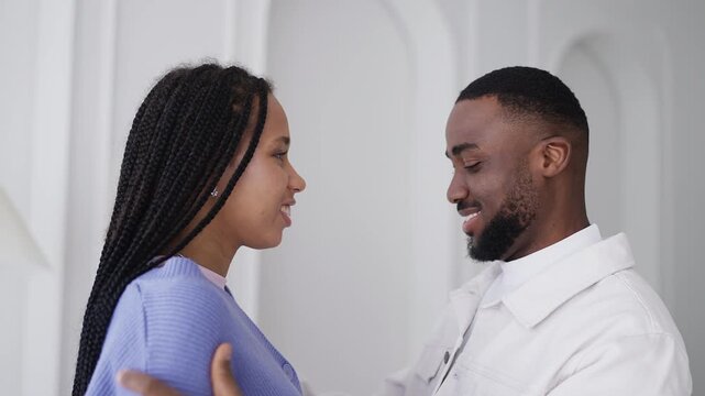 Happy Black boyfriend gently kisses girlfriend's nose, showing love and support