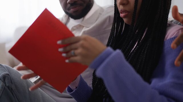 African American couple read bad news letter, upset about visa refusal