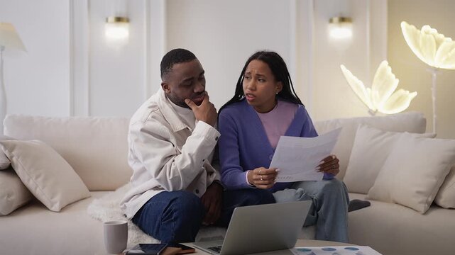 Worried Black couple check bills and taxes, upset about unpaid debts