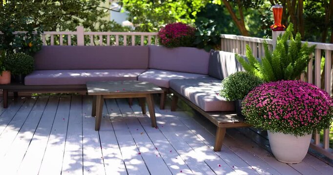Cozy Outdoor Terrace with Sectional Sofa and Colorful Potted Chrysanthemums