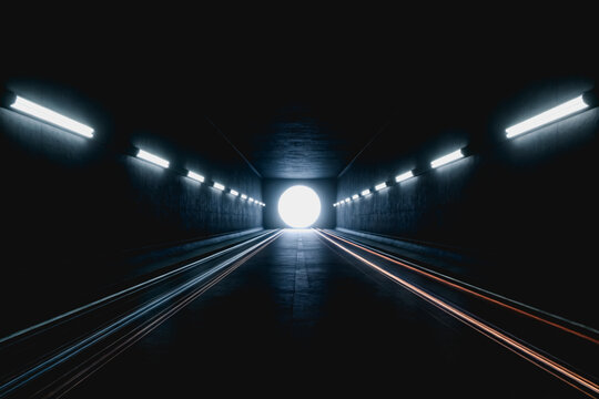 An empty underground tunnel with parallel tracks, linear wall lights, and a bright circular light at its far end, creating a perspective view.