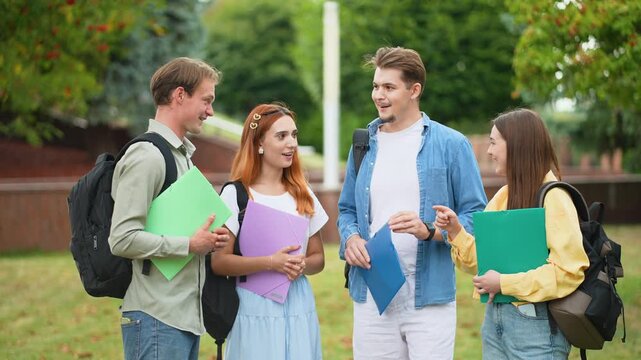 University students discussing project on campus outdoors