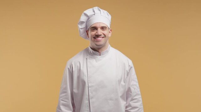 Clean culinary portrait of friendly professional male chef for restaurant branding, cooking services, hospitality and food advertising.