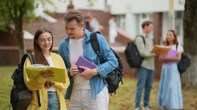 University students talking together on campus lawn
