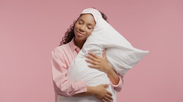Young woman peacefully sleeping, hugging and gently stroking soft pillow. Cozy bedroom scene comfort, relaxation, bedtime routine