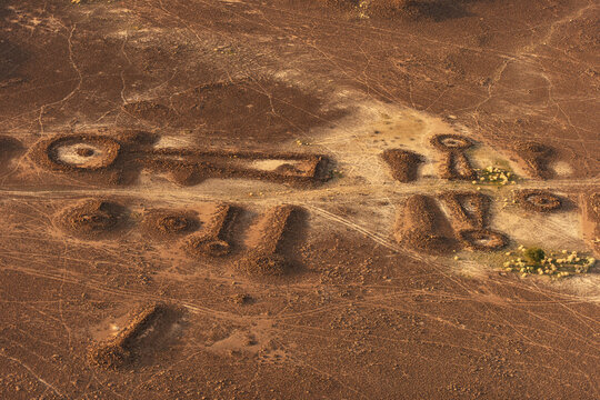 Aerial view of the prehistoric ring cairns and pendant tombs scattered across the arid desert landscape in Khaybar, Al Madinah Province, Saudi Arabia.
