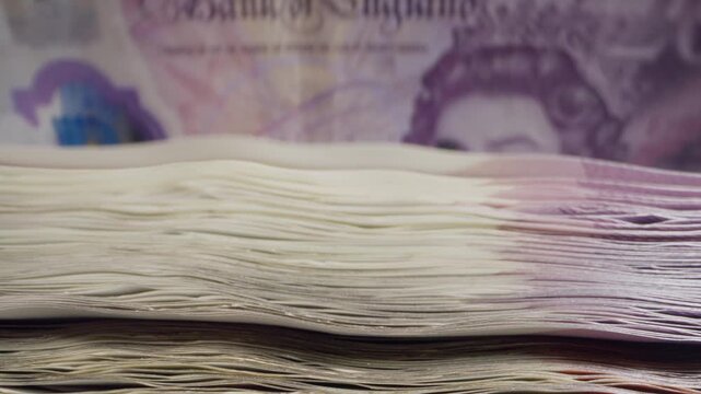 British Pound Banknotes Being Counted And Verified By An Automatic Cash Counter. Secure currency processing with counterfeit detection