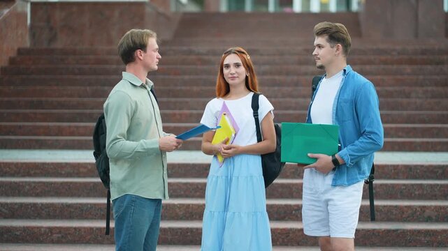 University students talking together on campus stairs