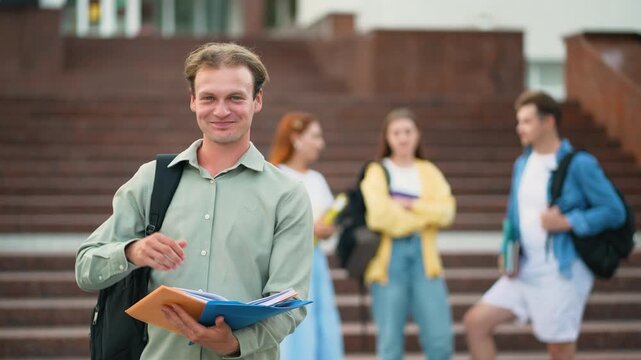 University student showing thumbs up in front of campus building