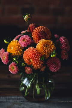 Elegant bouquet of beautiful bright colourful dahlias in a glass vase. Autumn mood, fall vibes. Birthday greeting postcard