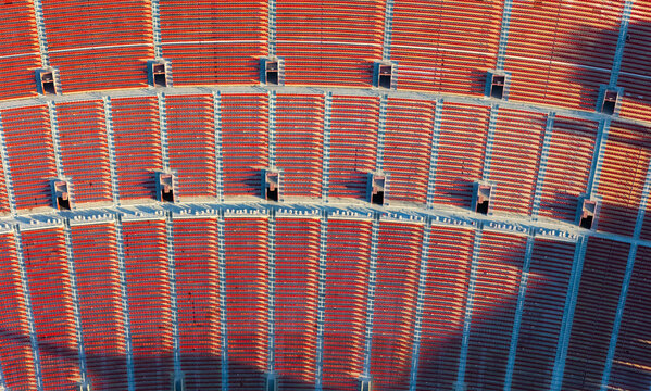 Aerial view of the LA Memorial Coliseum showing the empty red stadium seating rows in Los Angeles, California, United States.