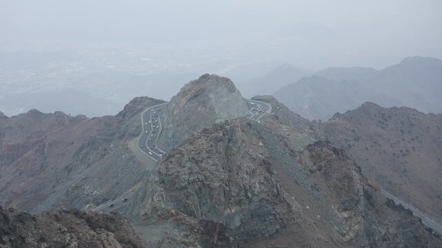 Taif,  Saudi Arabia - Night time-lapse of illuminated winding mountain road in Al Hada, Taif with city lights and traffic, 4K footage video