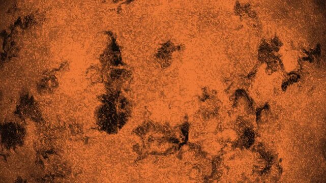 Grungy abstract texture motion background with distressed orange and black organic patterns, weathered vintage surface with rustic stains and dark vignette for cinematic overlay or industrial design.