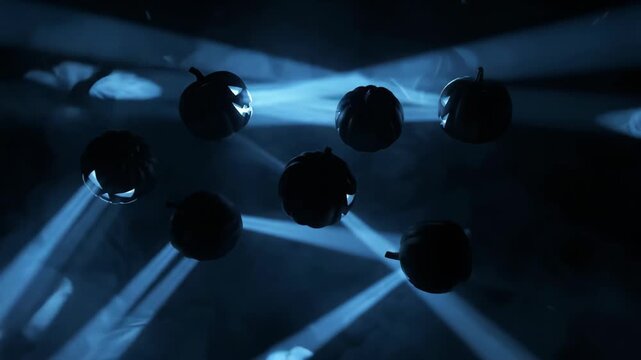 Jack-o'-lanterns with glowing blue light beams in dark spooky fog, wide shot, loop animation