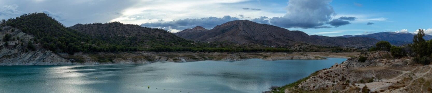 Panoramic view of Amadorio Reservoir with turquoise water and hills in Alicante, Spain