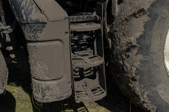 Muddy foot steps and tire tread seen on farm tractor in Spanish rice fields