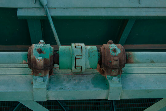 Close up of mechanical drive shafts and bearings on spillway gate at Amadorio Dam in Spain