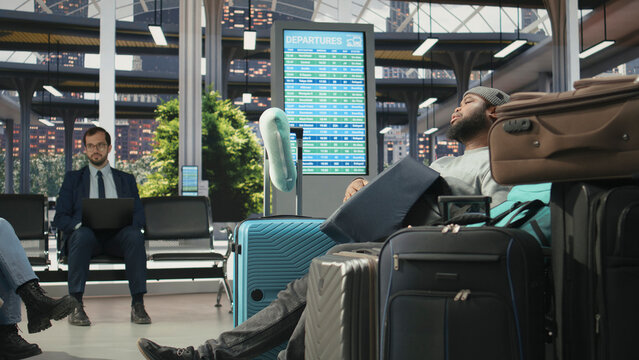 Tired passenger struggling to carry heavy baggage at bus terminal