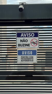 Security Camera and Warning Signs on Automatic Residential Gate in Brazil
