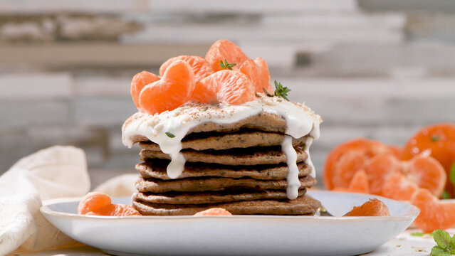 Stacked Oat Pancakes with Yogurt and Tangerine Slices