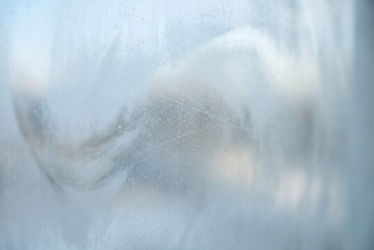 Frosted scratched glass texture in cool blue and grey