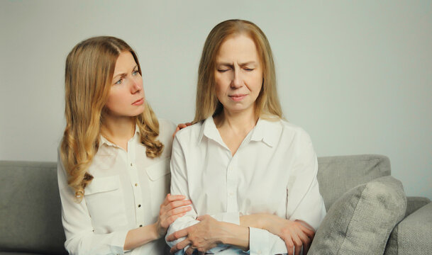 Upset offended caucasian two women, mature mother or sister and adult daughter together at home
