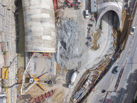 Aerial view of a tunnel construction site featuring large concrete segments, heavy machinery, and a concrete mixer truck in Istanbul, Istanbul, Turkiye.