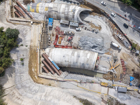 Aerial view of a tunnel construction site featuring large concrete tunnel segments, heavy machinery, and excavation work in Istanbul, Istanbul, Turkiye.