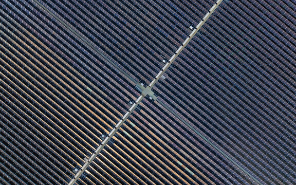 Aerial view of floating solar panels arranged in geometric patterns on the water surface in The Netherlands.
