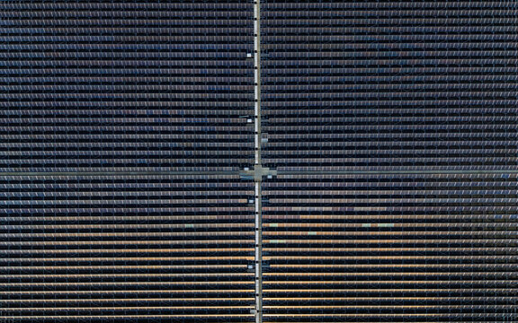 Aerial view of a large floating solar farm with rows of photovoltaic panels on water in the netherlands.