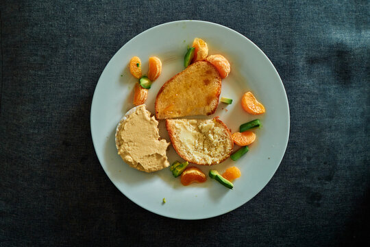 Overhead View of a Snack Plate With Toast, Hummus and Fruit on a Sofa