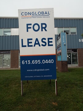 Gloucester, Ontario, Canada &ndash; July 31, 2026: A tall "For Lease" sign from CDN Global stands on the lawn in front of a commercial building on Canotek Rd.